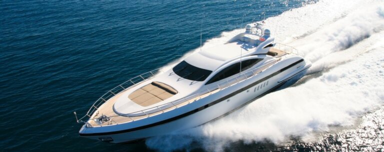 Elliman Yachts luxury yacht cruising on blue water - Douglas Elliman yacht division